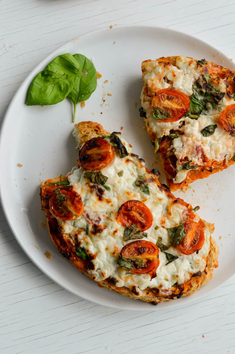 Two slices of cottage cheese toast with a bite.