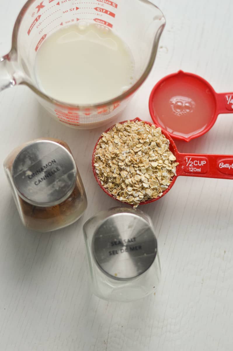 Ingredients for oatmeal including oats, egg whites, and milk.