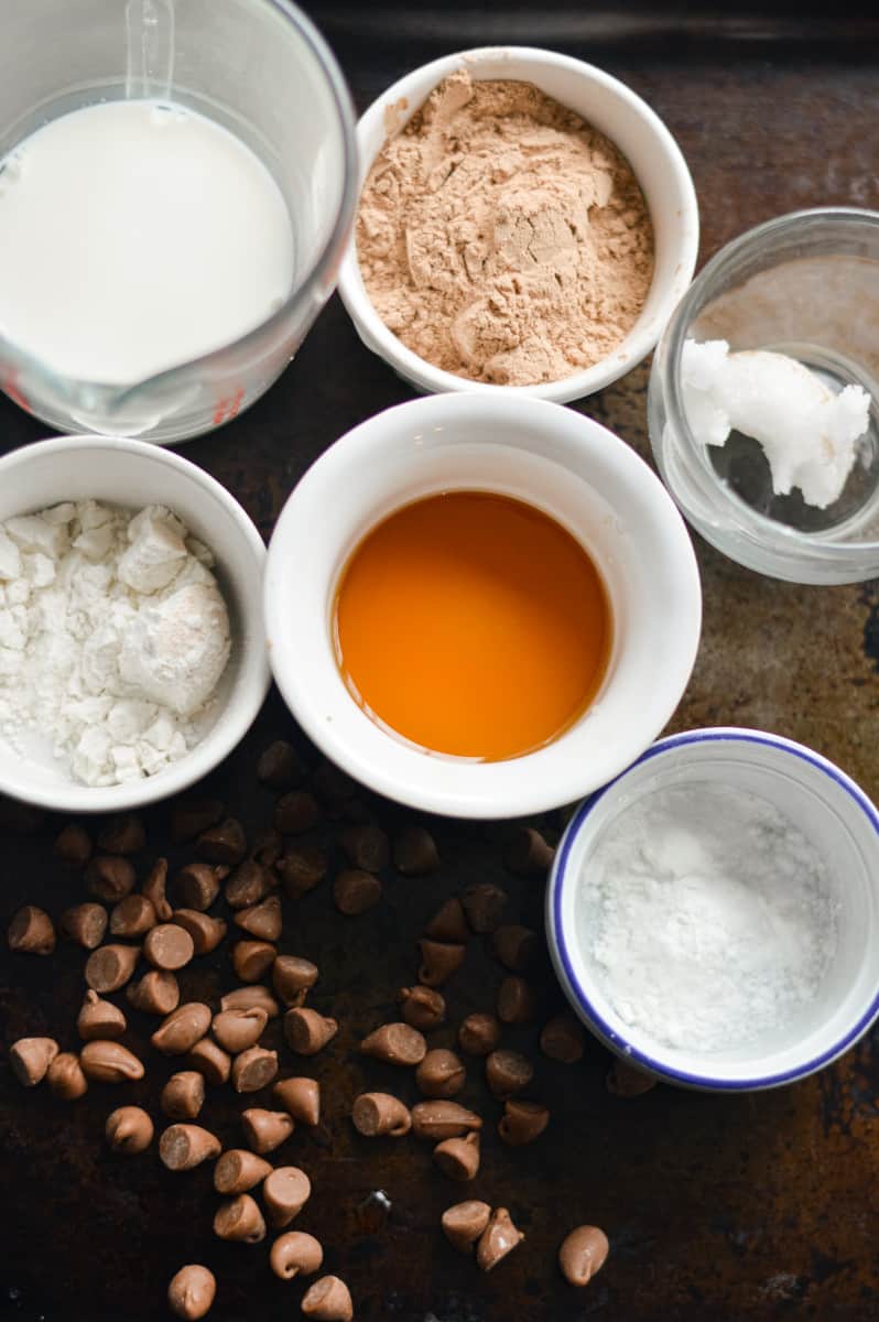 Ingredients for protein mug cake including flour, milk, protein powder and chocolate chips.