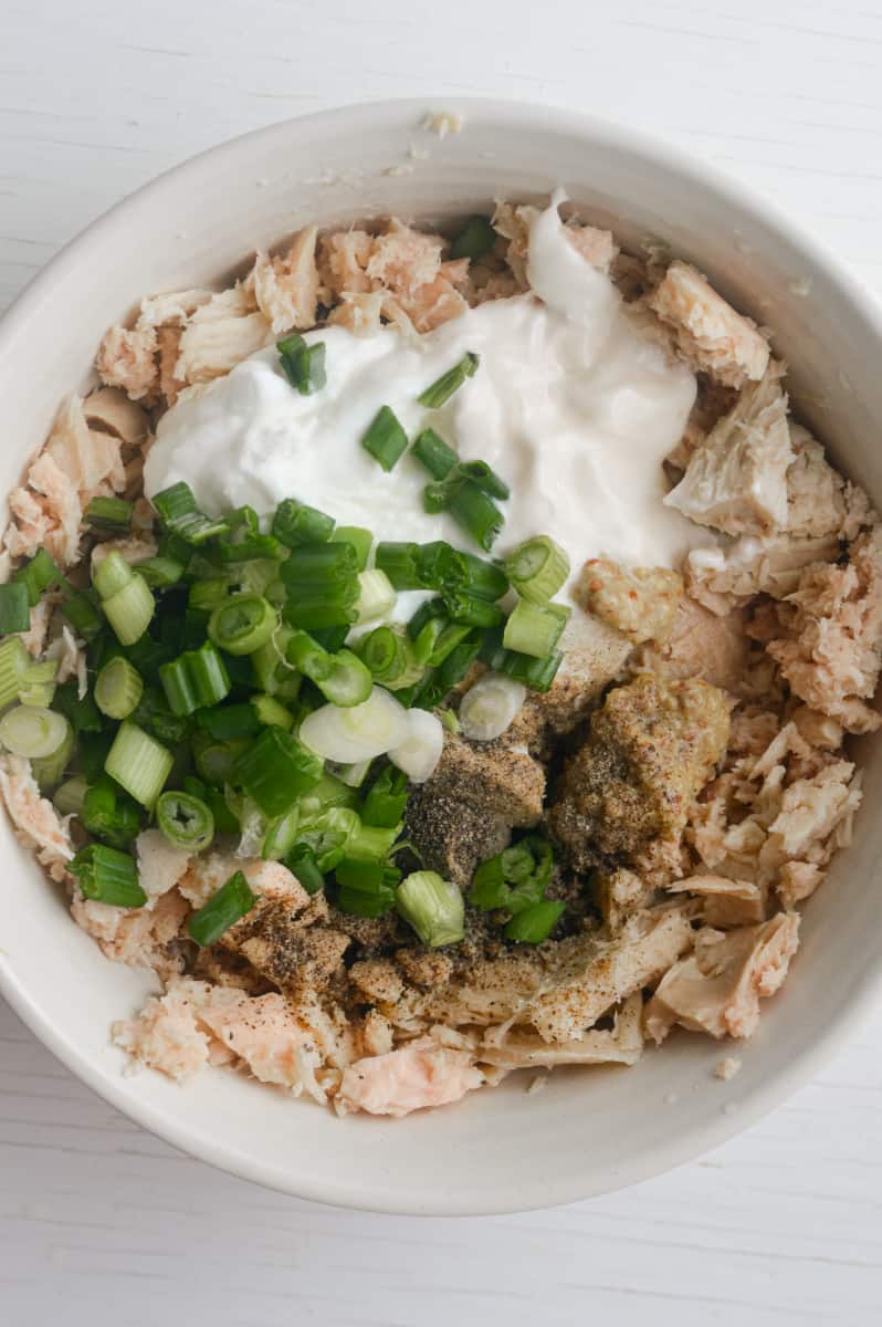 Adding ingredients for tuna salad.