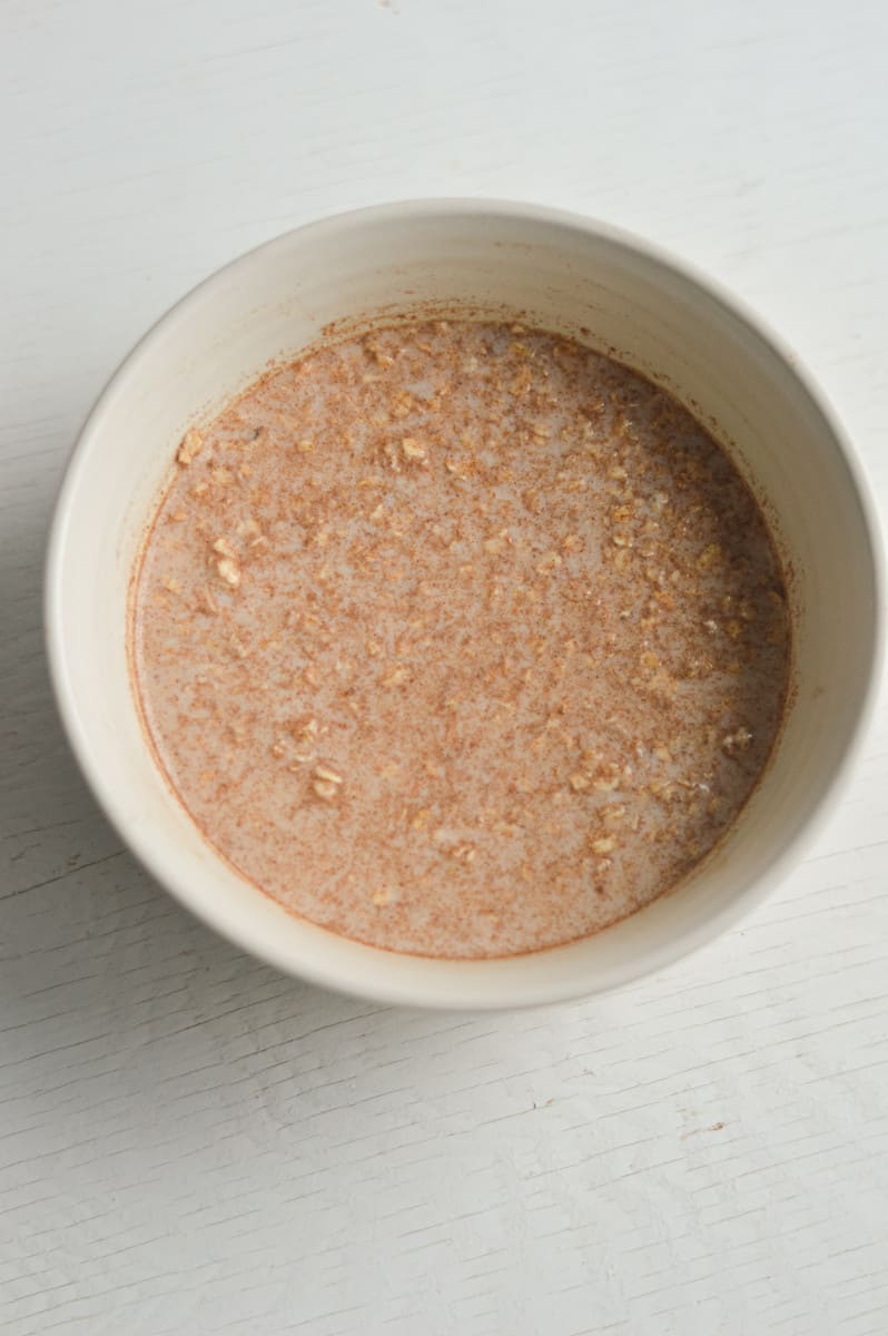 Mixing together oats, egg white and milk in a bowl.