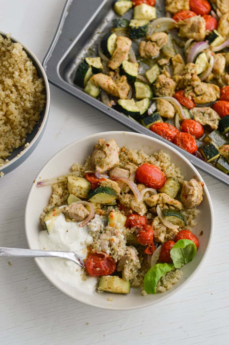 Serving pesto chicken quinoa bowls with whipped feta dressing.