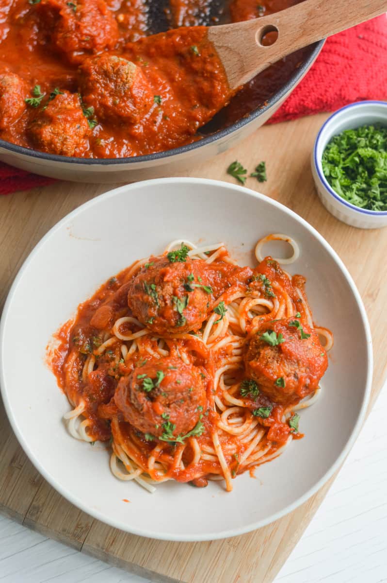 Spaghetti and tofu meatballs in a bowl.