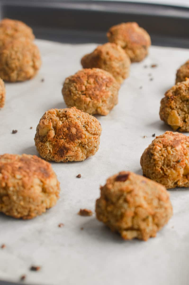 Cooked tofu meatballs on a tray.