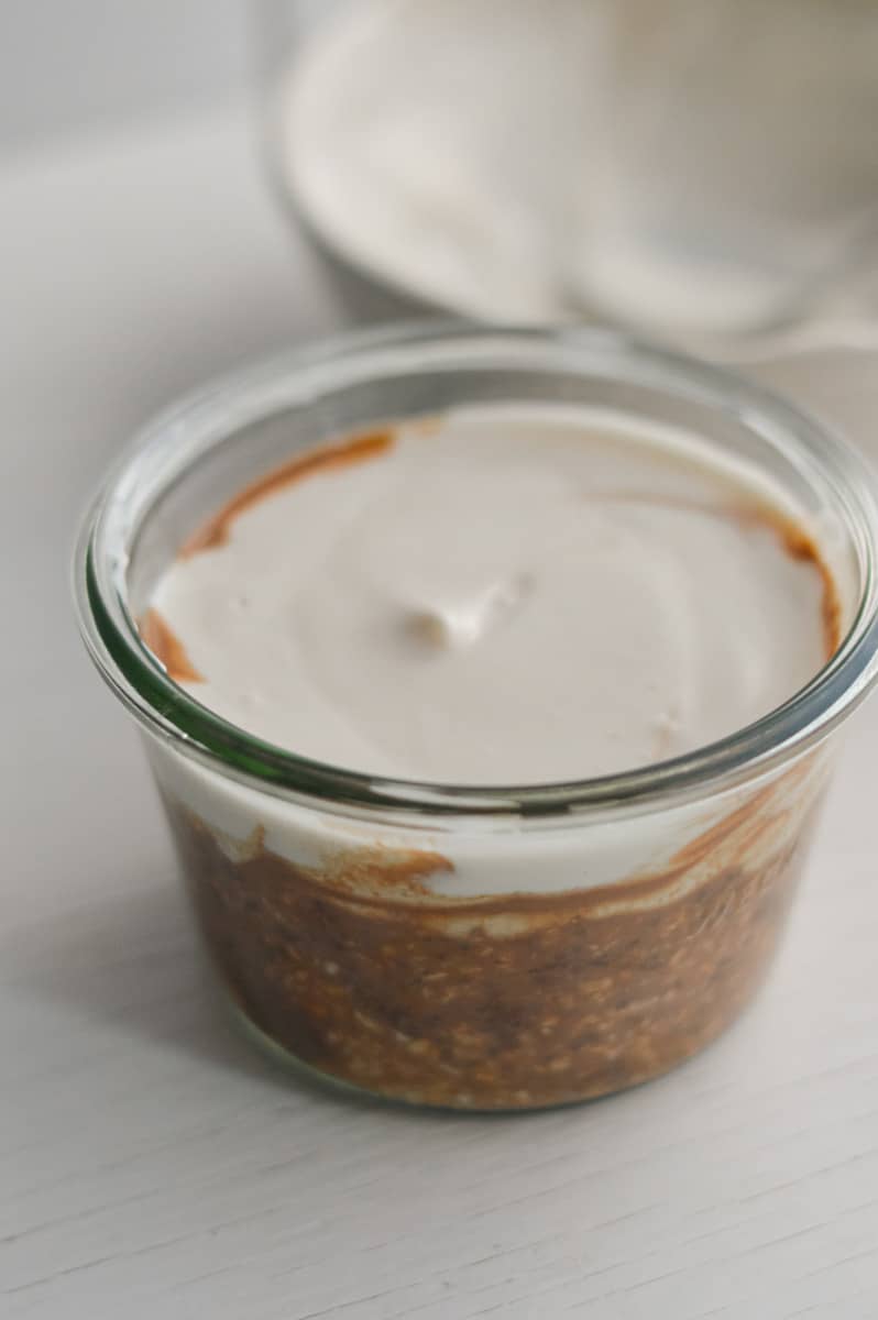 Adding creamy topping to coffee base.