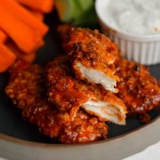 Air fryer buffalo chicken tenders cut in half.