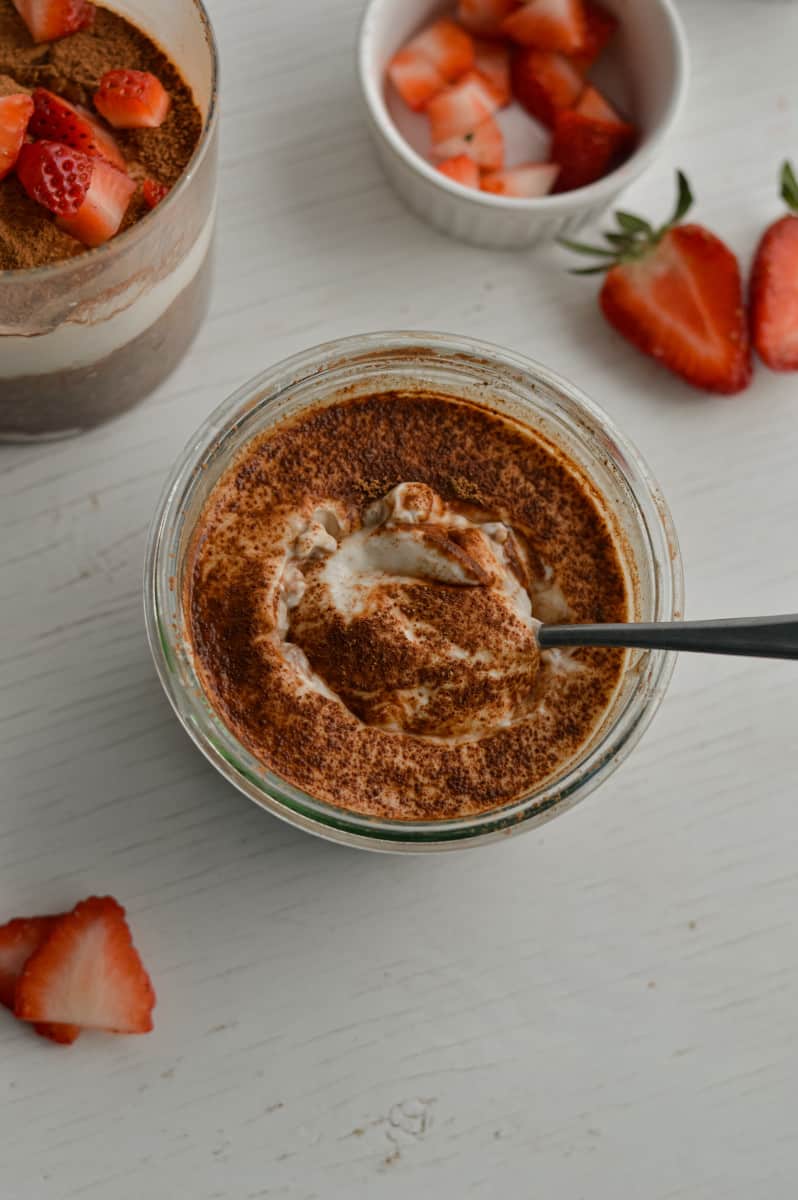 Tiramisu overnight oats served with strawberries.