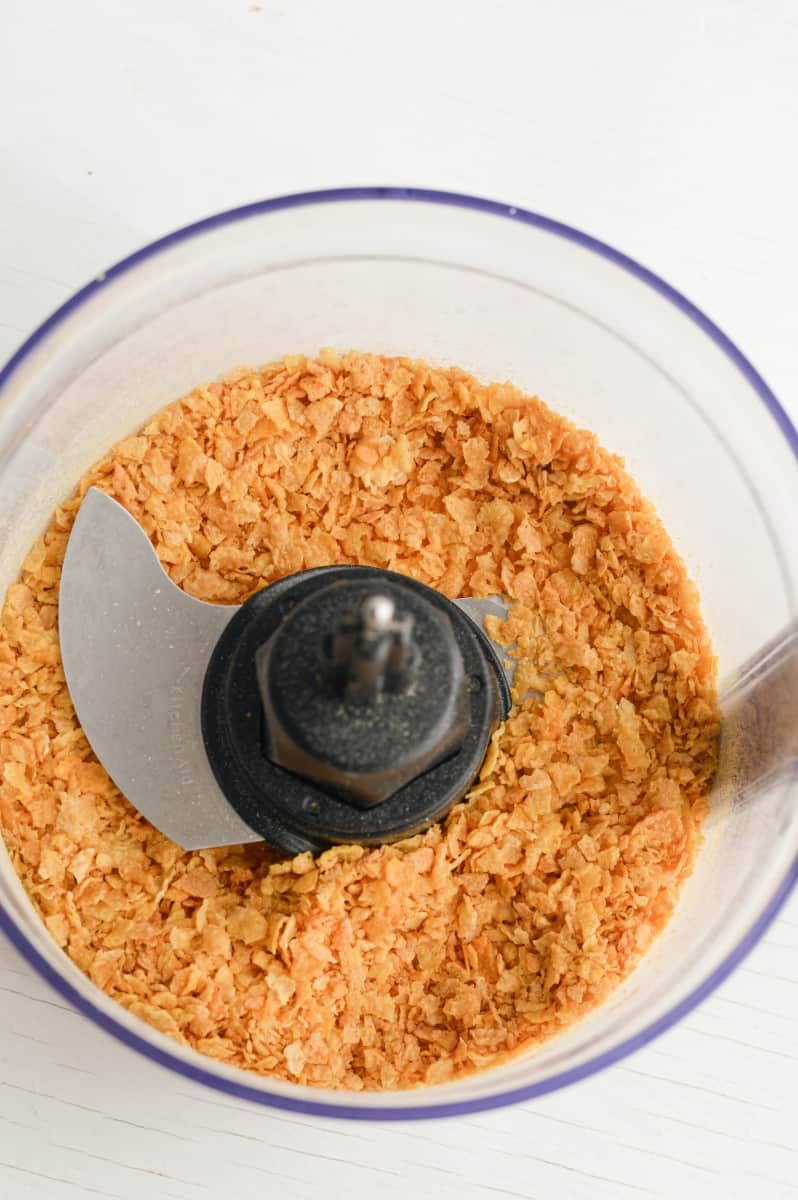 Blitzing corn flakes in a food processor.
