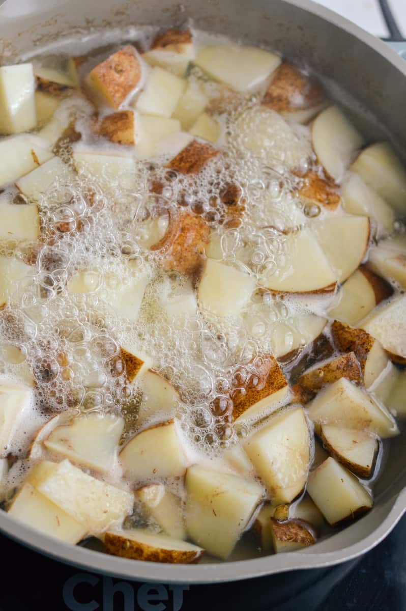 Simmering potatoes until soft.