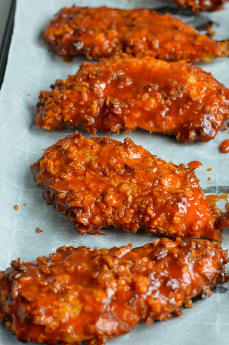 Close up of air fryer buffalo chicken tenders on a tray.