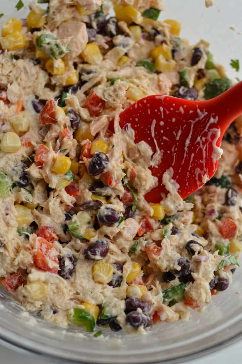 Combining tuna salad.