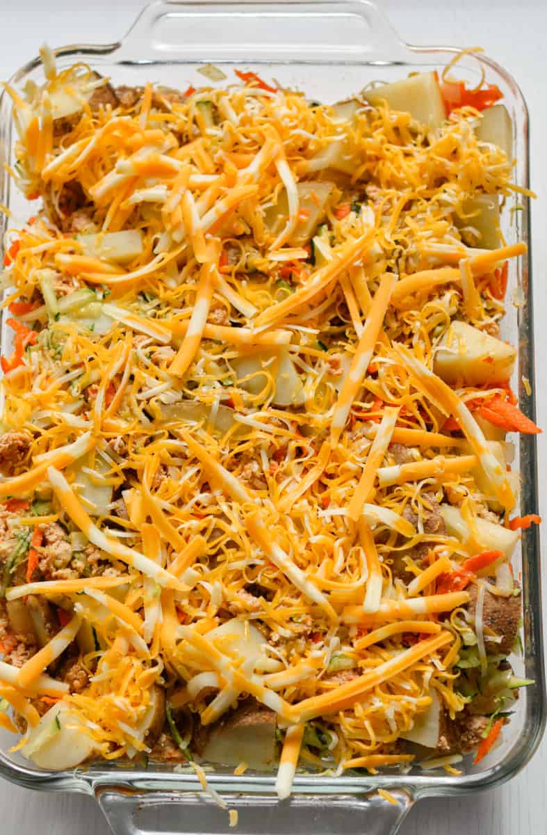 Topping casserole with cheese.