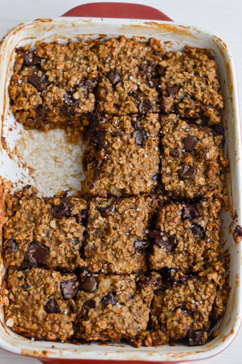 Cutting into a tray of peanut butter banana oatmeal bars.