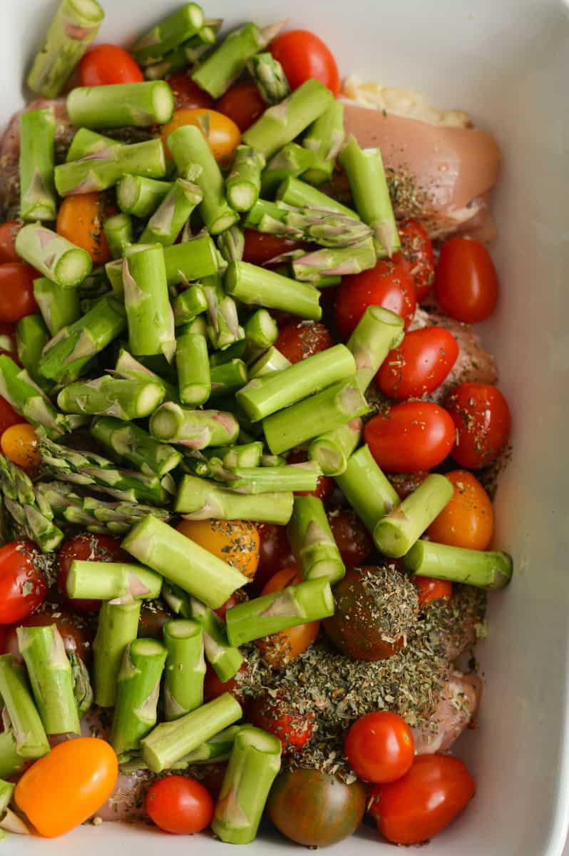 Adding chopped asparagus to casserole dish.