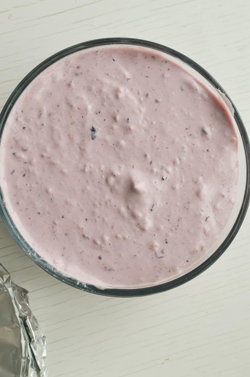 Transferring protein ice cream to a container to move to freezer.