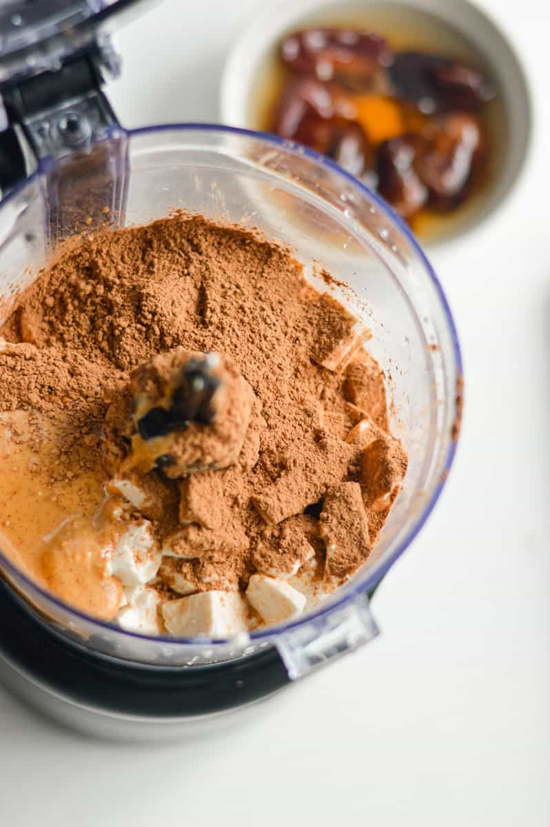Adding ingredients to a food processor.