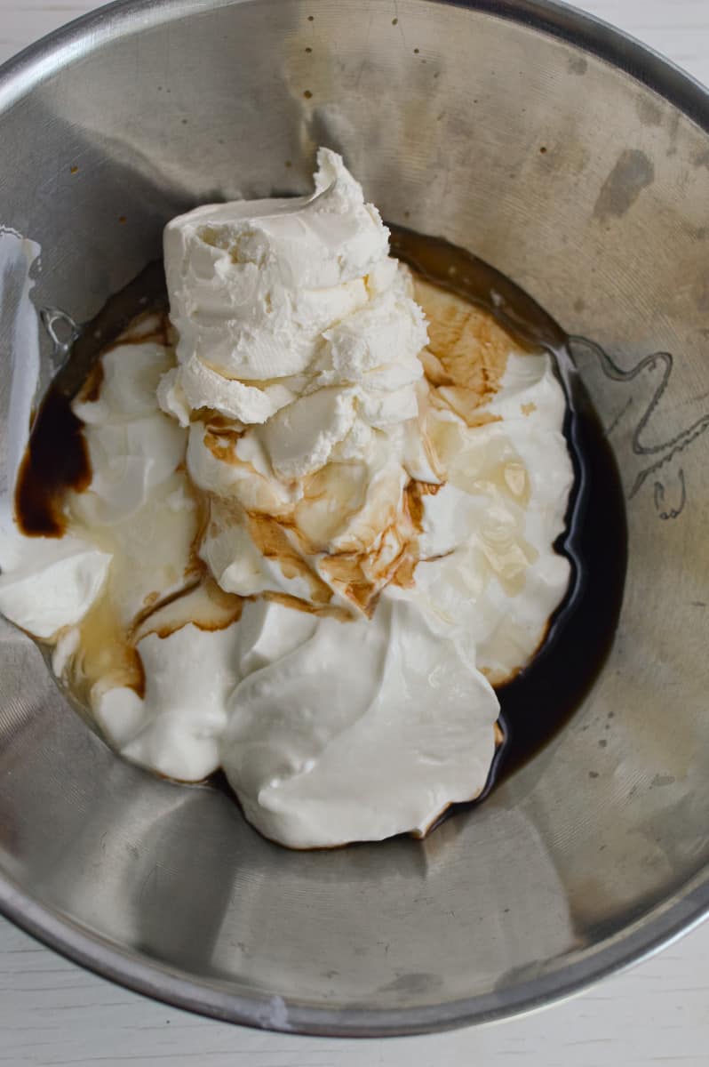 Adding cream cheese, yogurt and honey to a bowl.