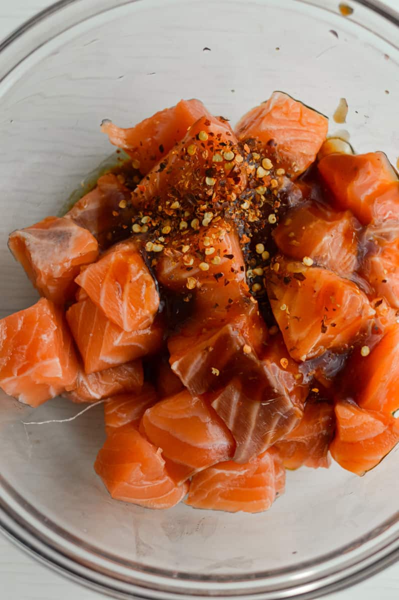 Adding ingredients to salmon.