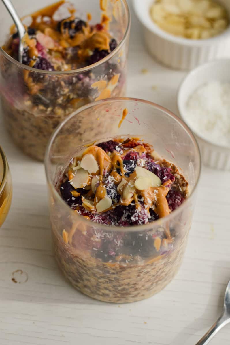 Overnight oats with frozen fruit, peanut butter and almonds in a jar.