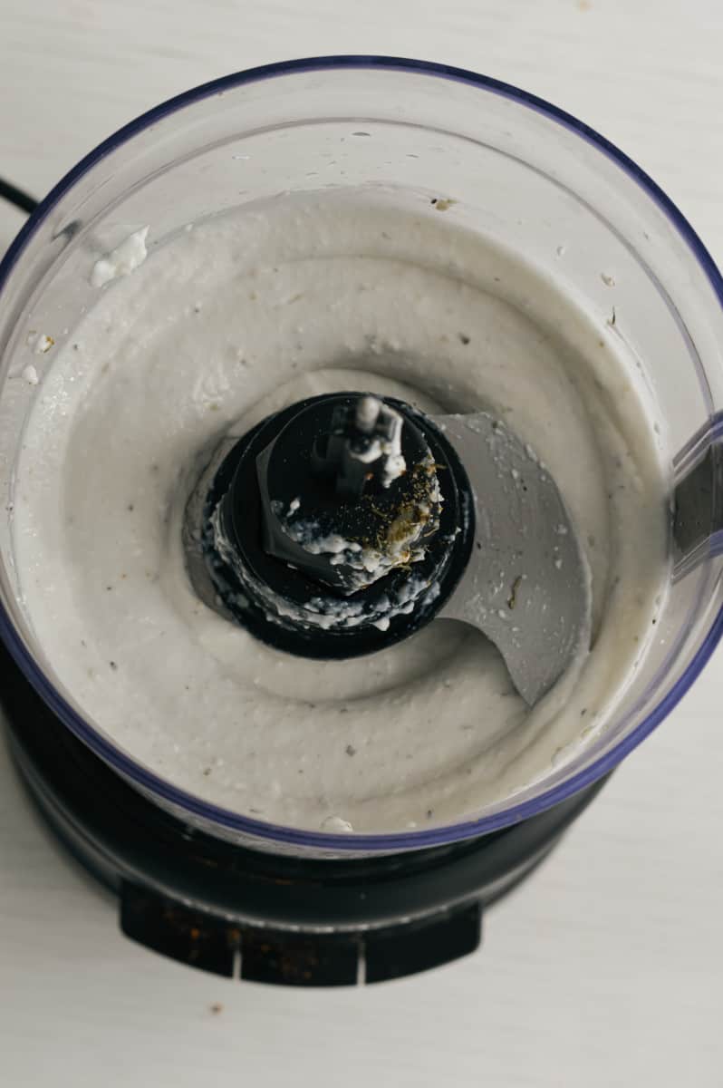 Blending cottage cheese in a food processor.