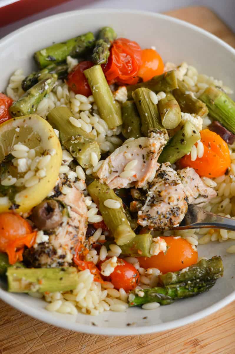 Bowl of baked chicken with feta and orzo.
