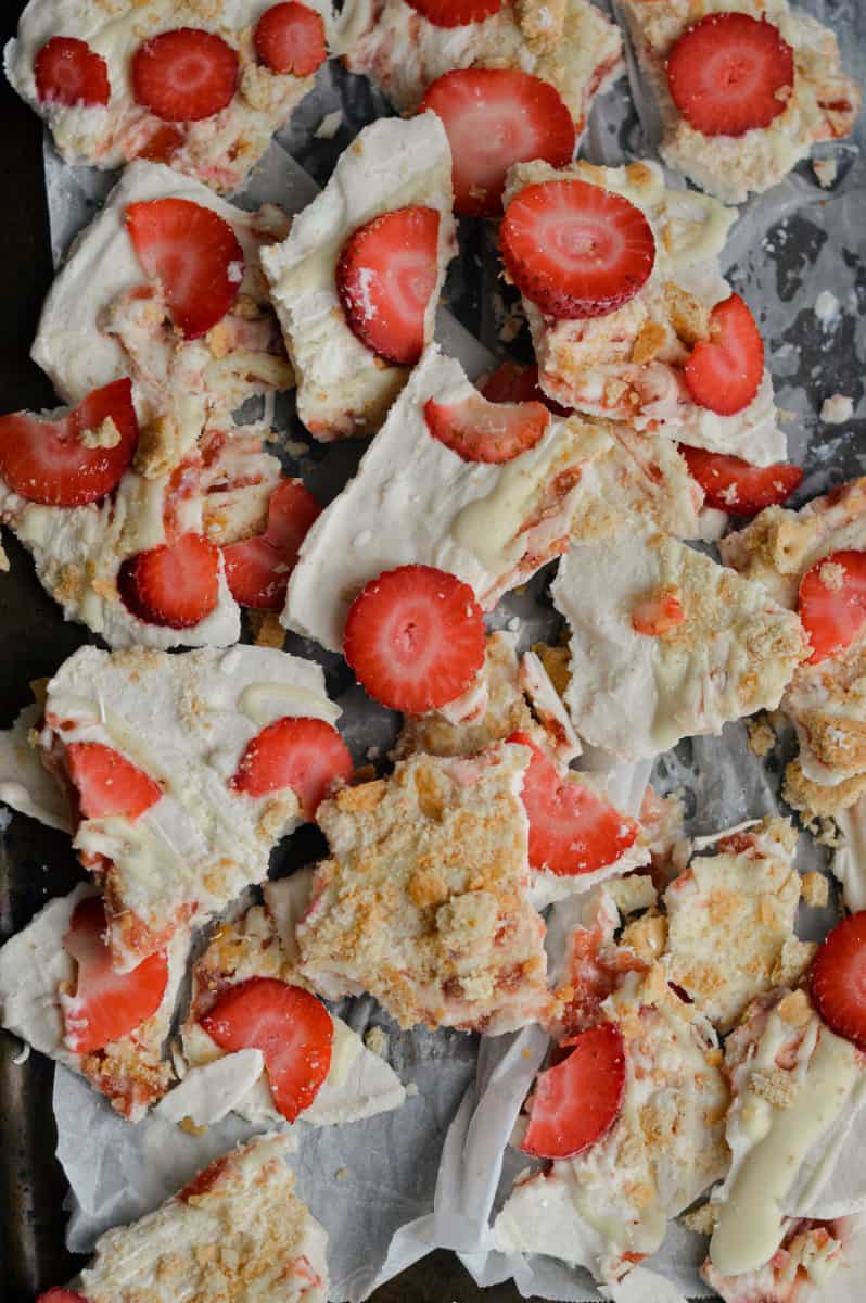 Breaking up cheesecake frozen yogurt bark.