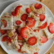 Plate of cheesecake frozen yogurt bars with strawberries.