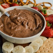 Chocolate vegan fruit dip on a dessert board.
