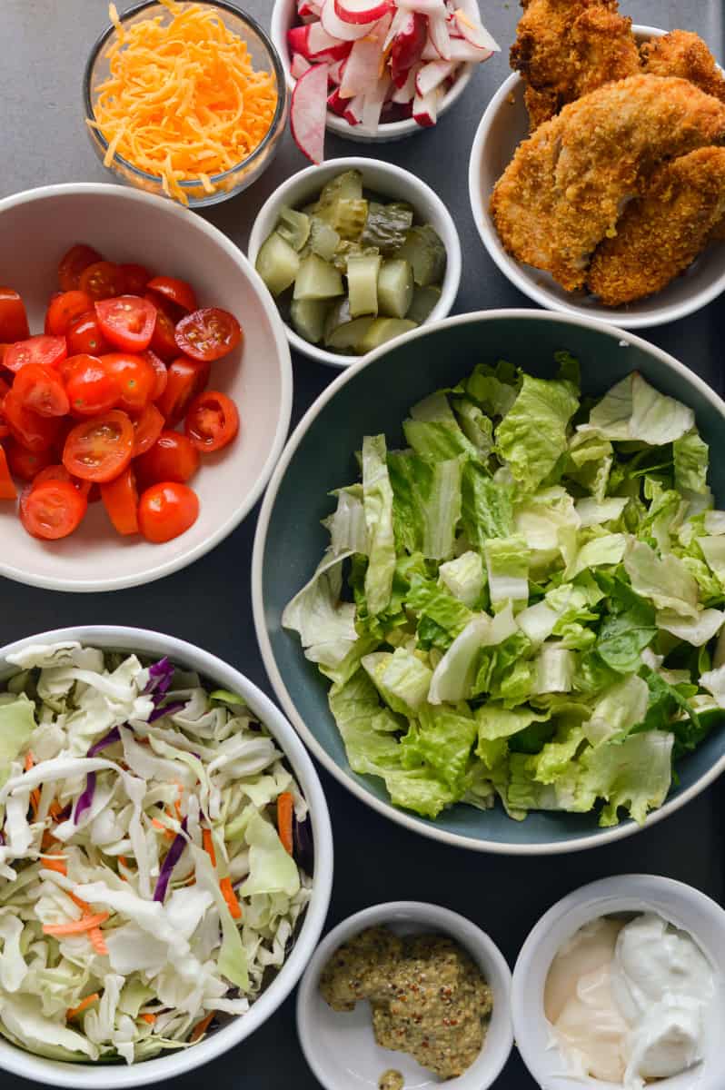 Ingredients for honey mustard chicken wraps in bowls.