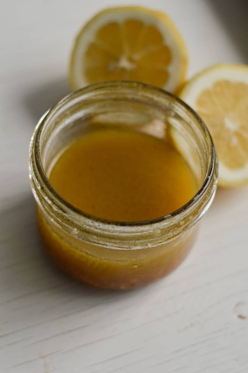 Whisking together ingredients for lemon caesar vinaigrette.