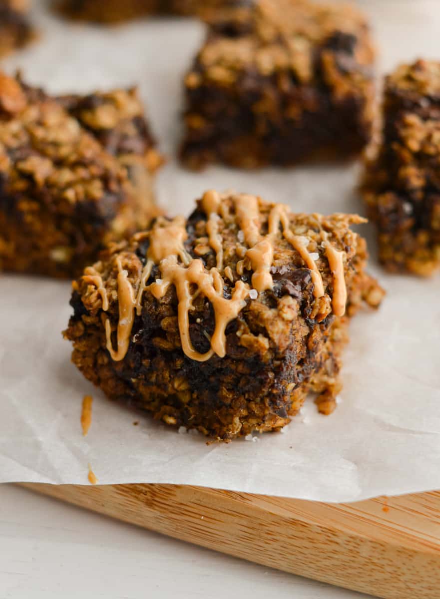 Close up of peanut butter oatmeal bars drizzled with peanut butter.
