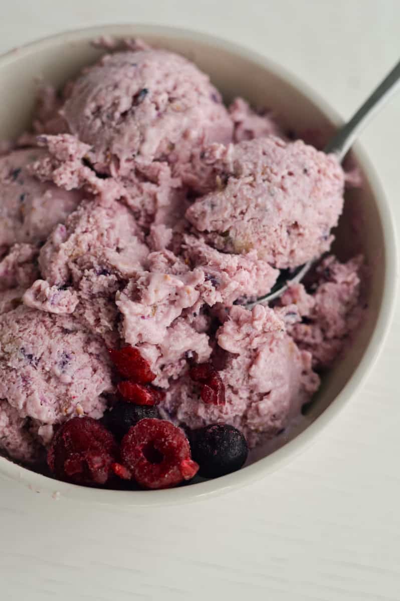 Cottage cheese ice cream in a bowl with a spoon.