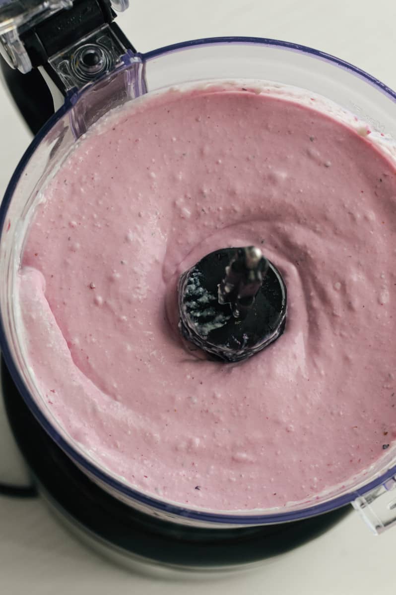 Blending cottage cheese ice cream in a food processor.