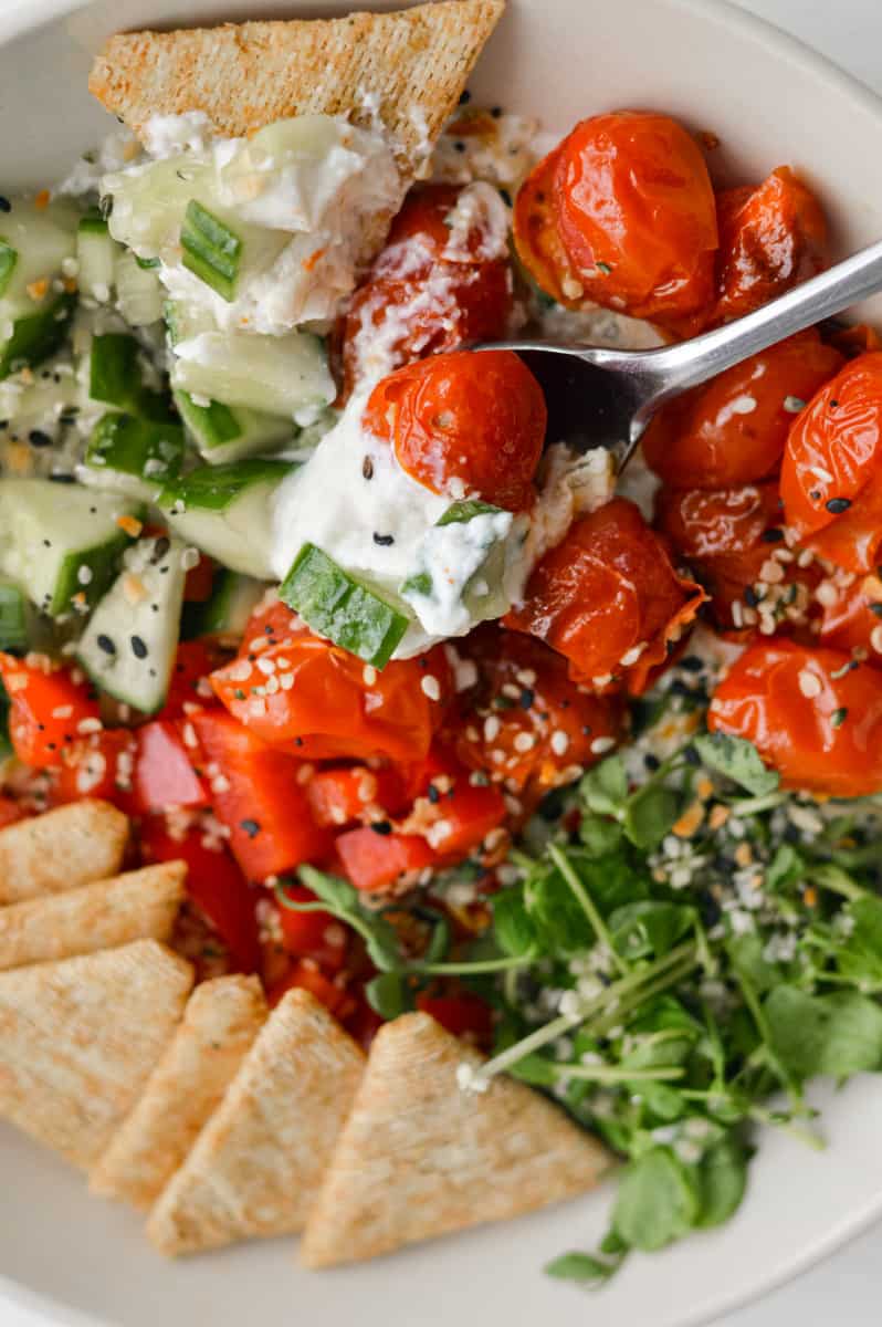 Taking a spoonful of savoury cottage cheese bowl.