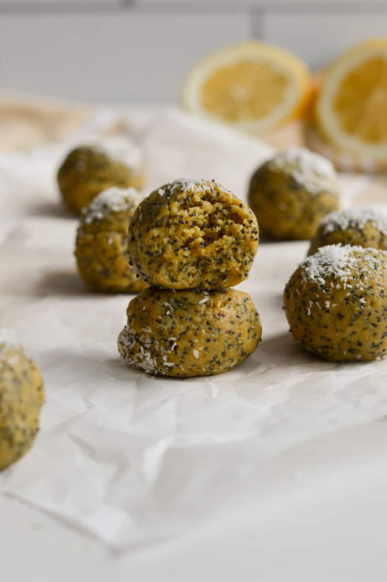 Two lemon turmeric energy balls stacked.