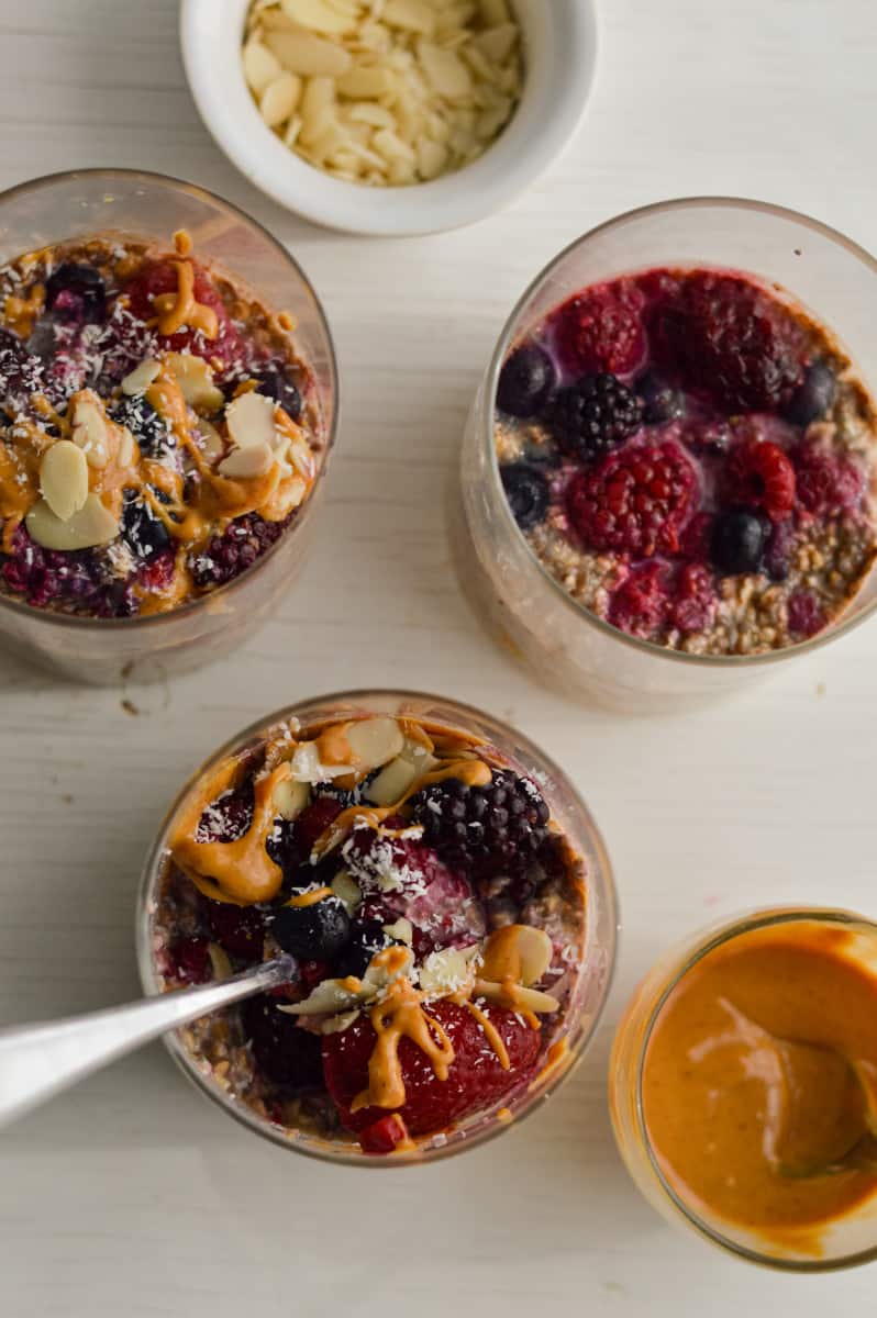 Toppings for overnight oats including peanut butter and almonds.