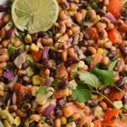 Vegan bean salad served with a lime slice.