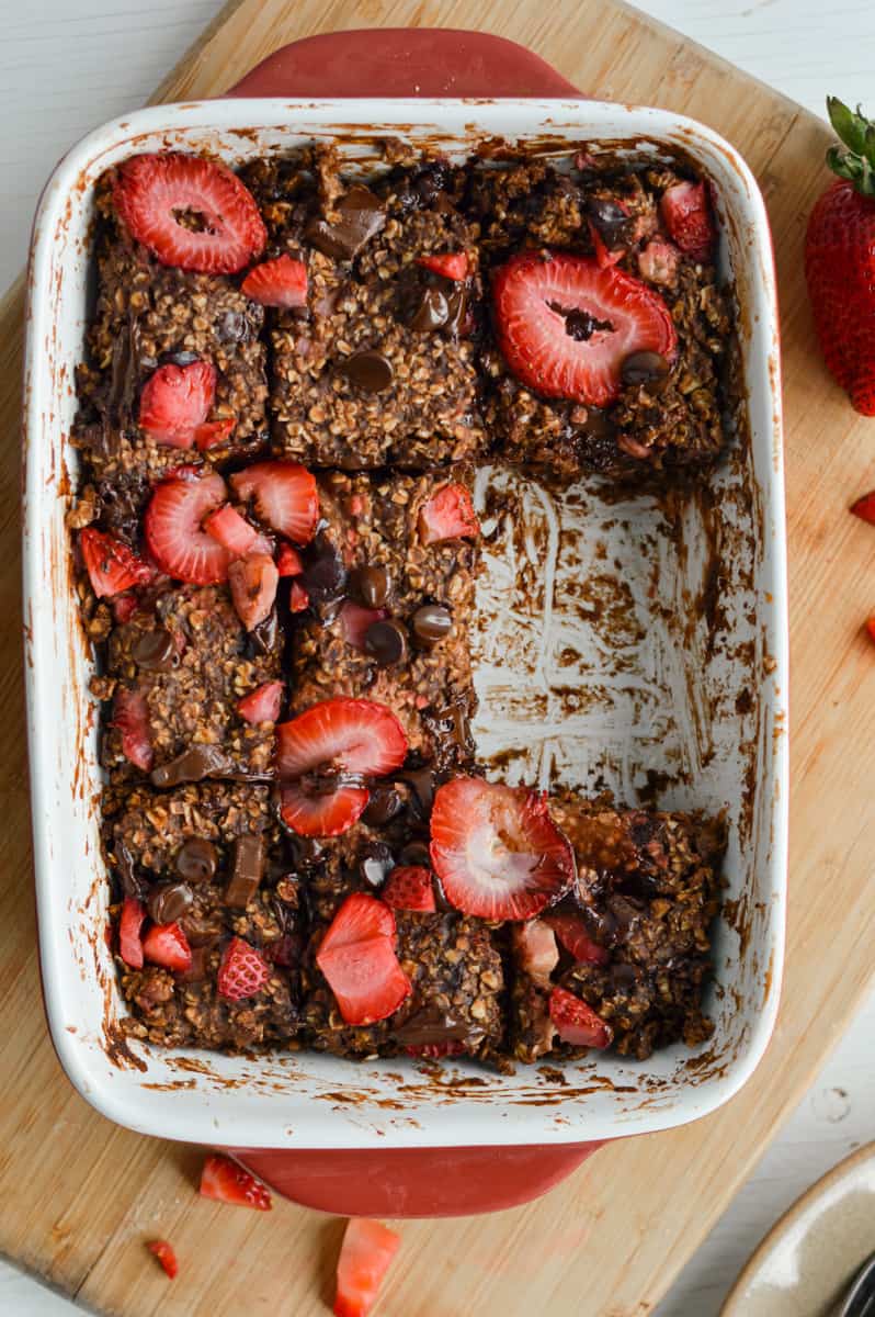 Tray of chocolate baked oats with a slice missing.