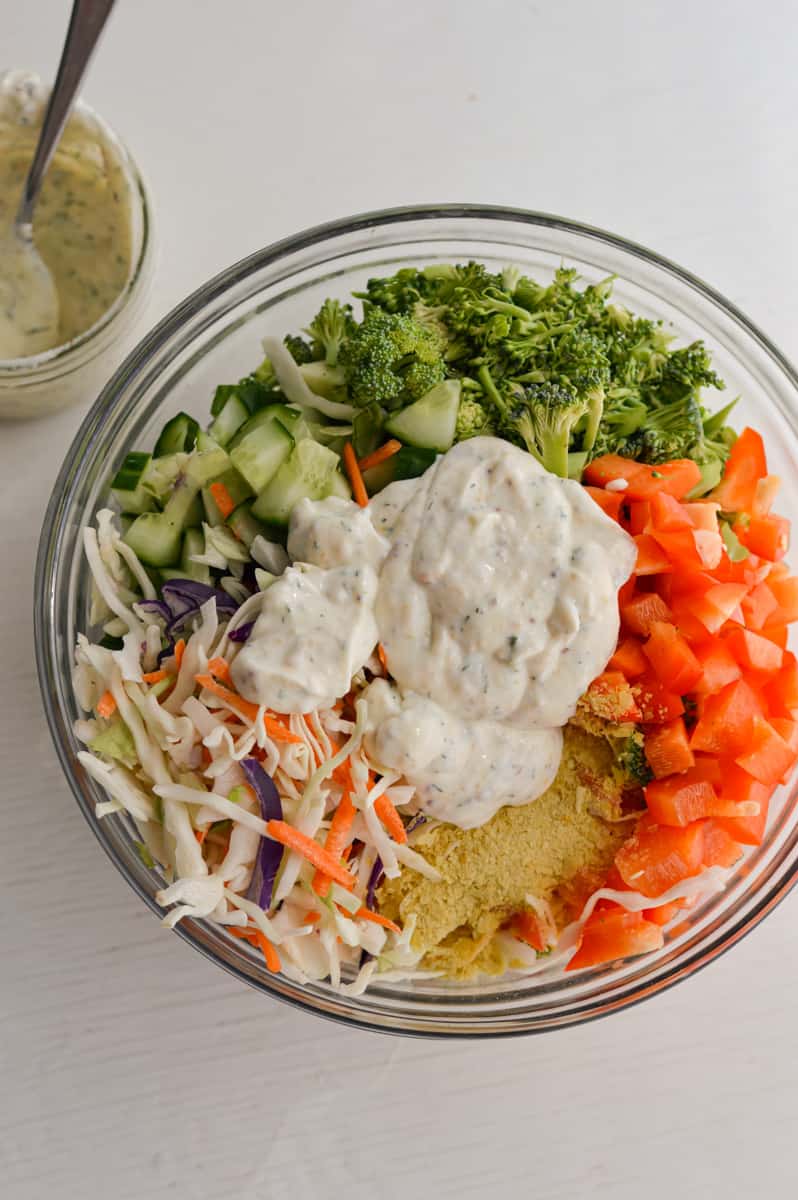 Adding greek yogurt ranch to pasta salad.
