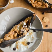 Air fried banana split served with yogurt in a bowl.