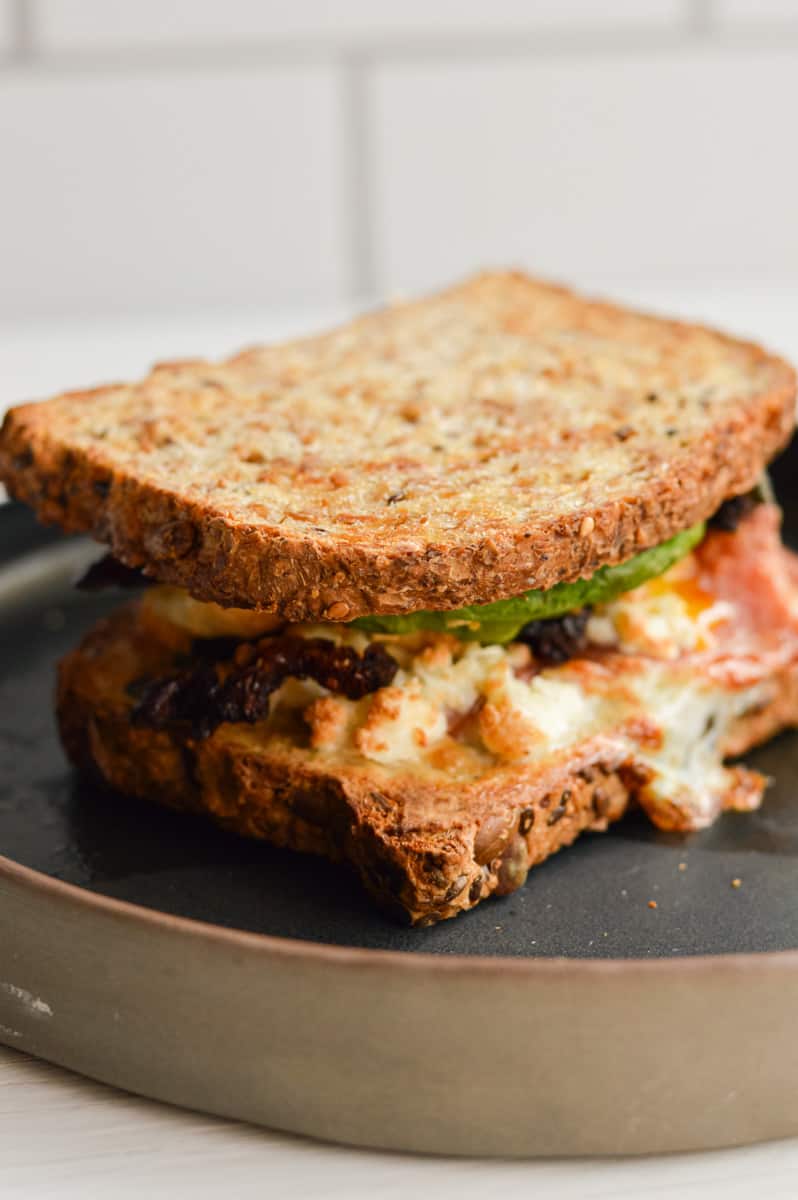 Uncut air fryer breakfast sandwich on a plate.