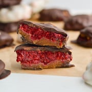 Chocolate covered raspberry jam bite cut in half.