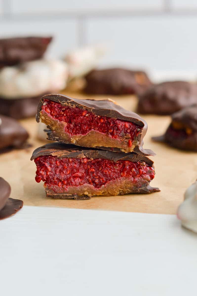 Chocolate covered raspberry jam bite cut in half.