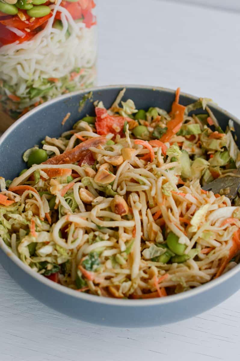 Close up of peanut noodle salad in a bowl.