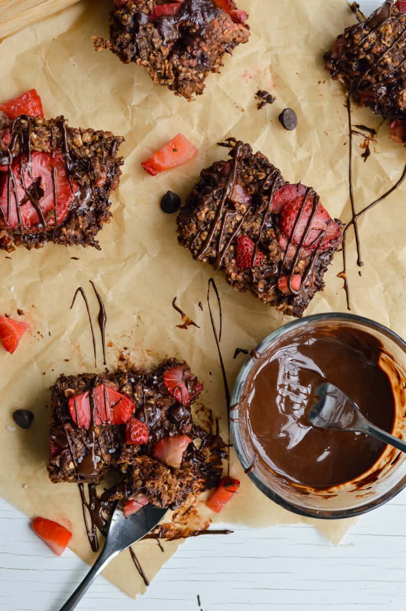 Drizzling vegan baked oats with melted chocolate.