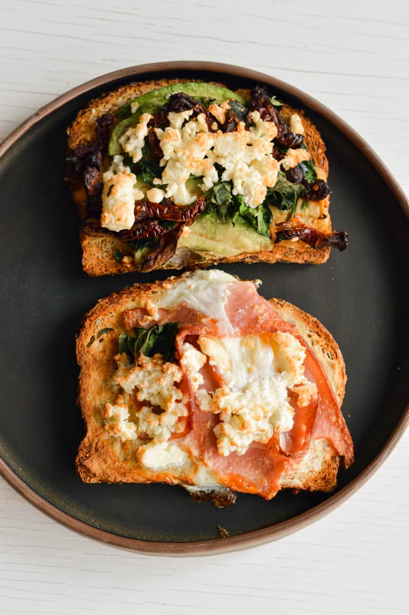Open faced breakfast sandwich on a plate.