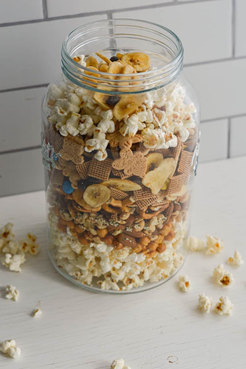 Popcorn trail mix in a glass jar.