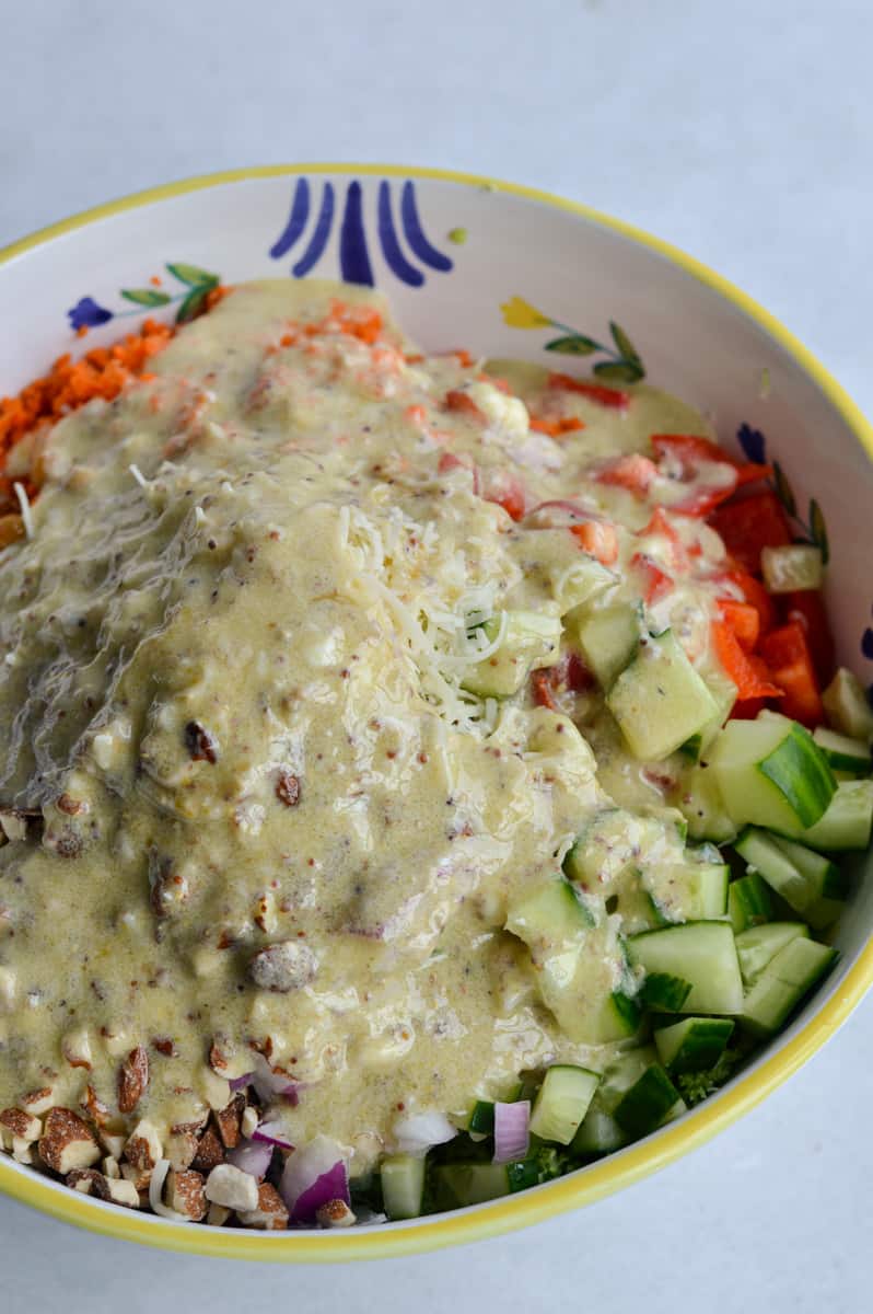 Mixing honey mustard dressing in broccoli crunch salad.