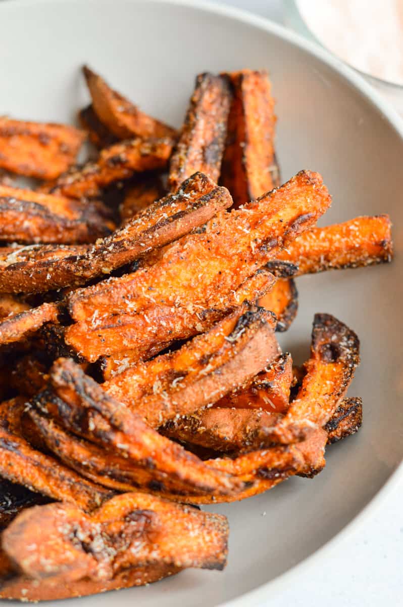 Close up of garlic parmesan air fryer sweet potato wedges.