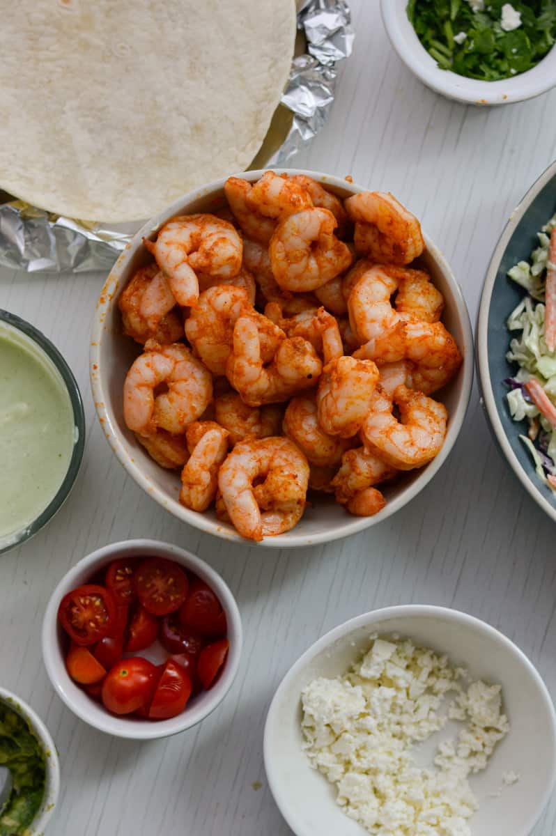 Assembling shrimp tacos.